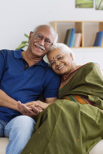 Image of an older couple sitting in a chair together